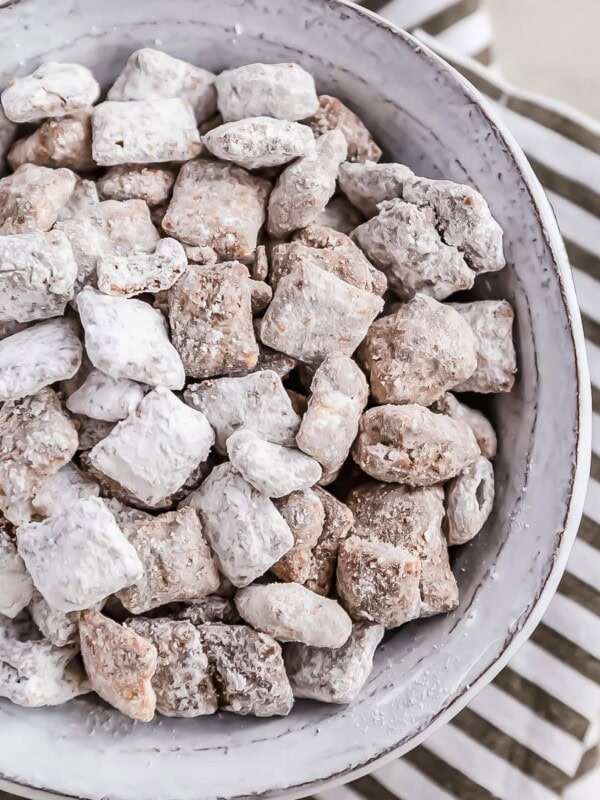 Puppy Chow is a chocolate-y treat that's sure to please! This easy puppy chow recipe includes an original version AND a mint chocolate puppy chow version. Find out how to make puppy chow for a simple yet delicious holiday treat!