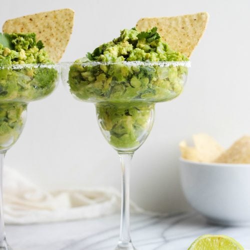 Guacamole Dip is a staple for game day, Cinco de Mayo, and summer parties. This delicious Margarita Guacamole Dip recipe is the perfect party dip, and it's so easy to make too. The secret? A bit of tequila mixed into the guacamole for an extra kick!