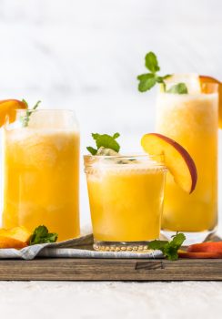 Peach Lemonade is our go-to summer drink! This easy peach drink is made with only 2 ingredients, both frozen so you can make this icy cold drink in minutes. This recipe can be served non-alcoholic to share with everyone, or you can turn it into a delicious peach cocktail with just a bit of vodka. This refreshing drink was just made for Summer. I'm in love!