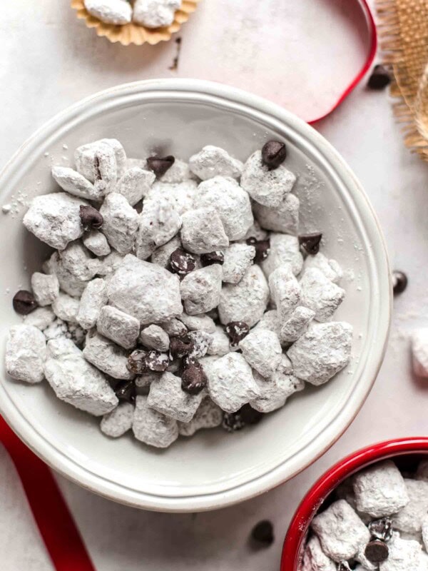 Salted Caramel Puppy Chow is so addicting! If you're a fan of puppy chow snack mix, you're going to love this flavor combo. Chex cereal topped with caramel, chocolate, and powdered sugar. YUM!