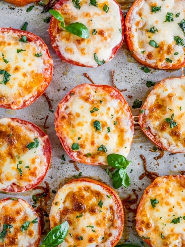 BAKED TOMATOES are a super quick and super easy side dish or appetizer for any occasion! These cheesy Baked Tomatoes with Mozzarella and Parmesan cheese are so simple yet incredibly delicious. They are always a hit when we make them and get eaten right away. These Baked Parmesan Tomatoes are just too tasty and fresh. 