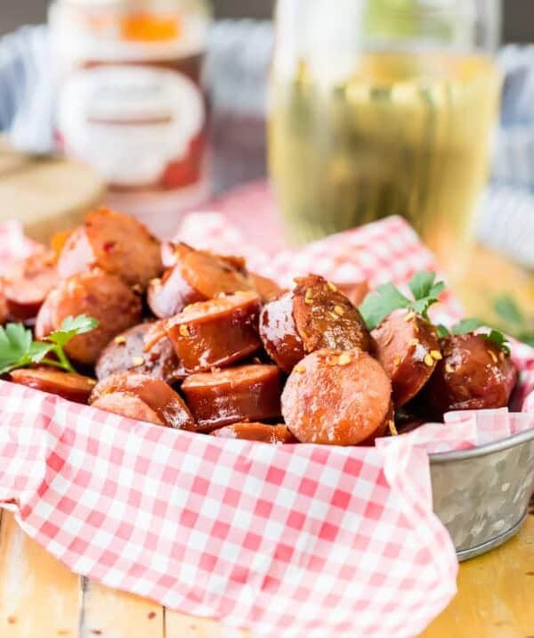 Crock Pot Kielbasa Sausage Bites are a tailgating favorite! This sweet and spicy kielbasa appetizer is SO EASY to make. There's nothing better than a slow cooker kielbasa recipe to make an easy game day appetizer. They are so addicting!