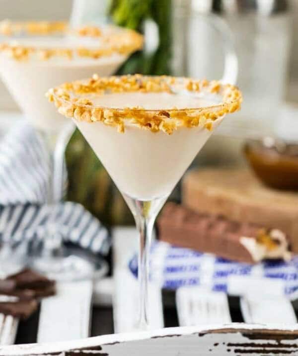 two martini glasses rimmed with crushed nuts