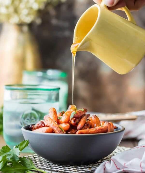 glaze poured over bowl of roasted carrots