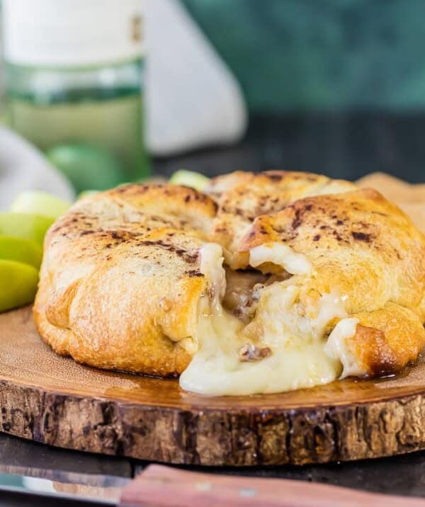 Apple Pie Baked Brie...a beautiful and delicious appetizer fit for any holiday party! We make this every Thanksgiving and Christmas and it's a party favorite every time!