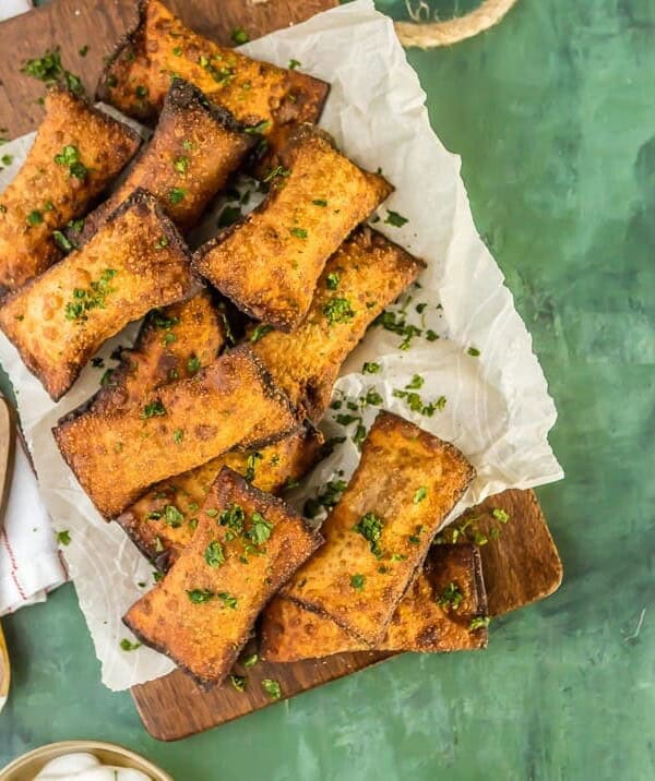 Mini Fried Taco Pizza Pockets...such a fun and simple appetizer or after school snack. ADDICTING! Fried Wontons stuffed with spicy beef, tomatoes, and cheese. These Taco Pizza Rolls are a favorite easy recipe!