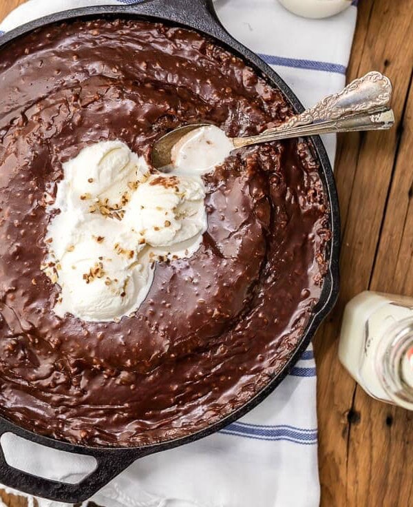 Texas Chocolate Sheet Cake is a classic, and this fun skillet version is just as gooey, chocolatey, and delicious! This easy chocolate cake recipe is just as easy as baking it in a sheet pan. Top this tasty skillet dessert with ice cream and dig in!