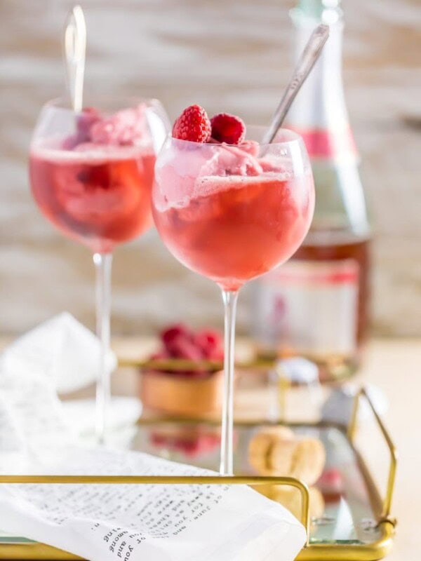 pink champagne floats in wine glasses on a tray