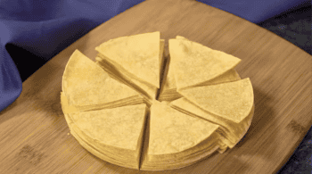 a stack of corn tortillas cut into 6 wedges.