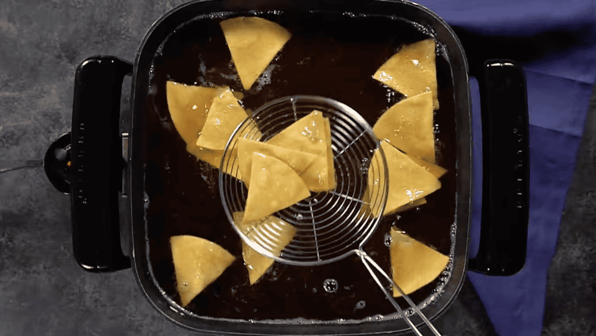 frying tortilla chips in oil.