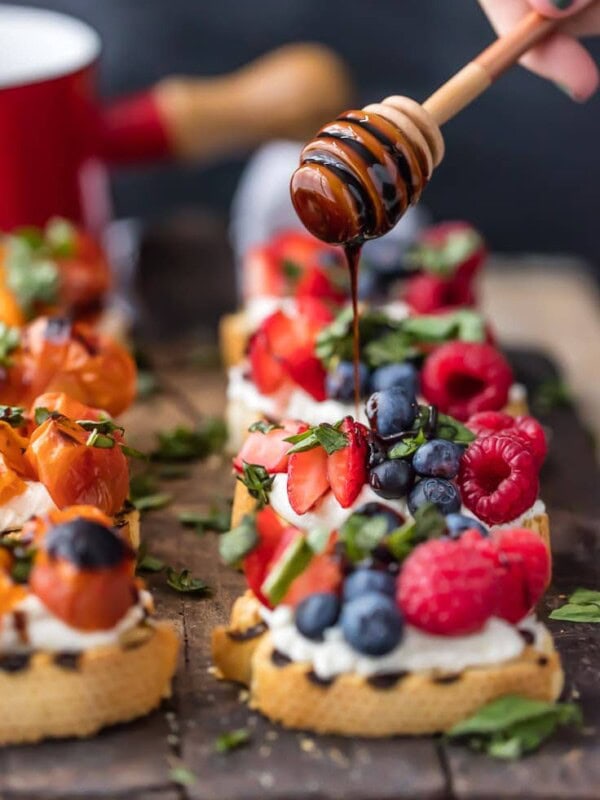 balsamic reduction being drizzled onto brushetta