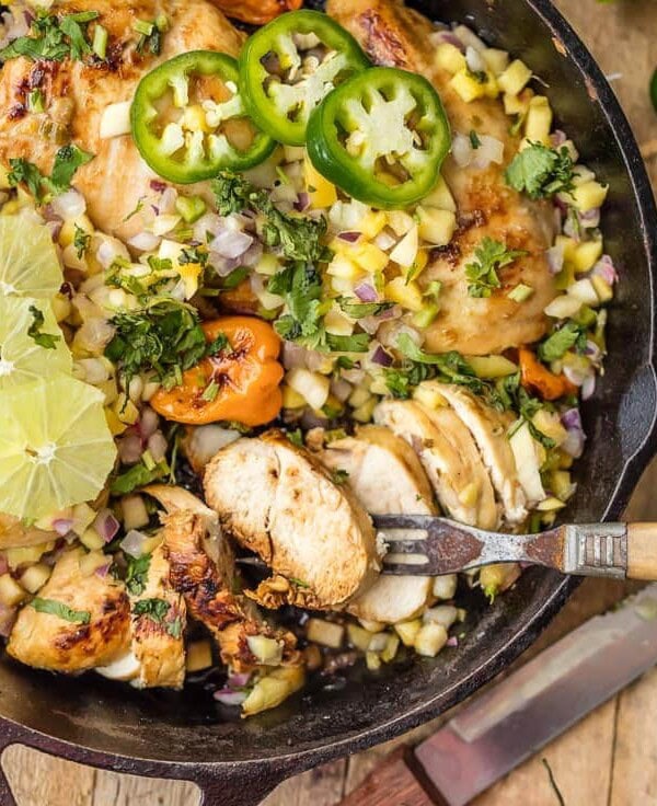 Make this SKINNY ONE PAN CARIBBEAN JERK CHICKEN SKILLET in just 15 minutes! Topped with mango salsa for a cool kick. A delicious and easy weeknight meal!