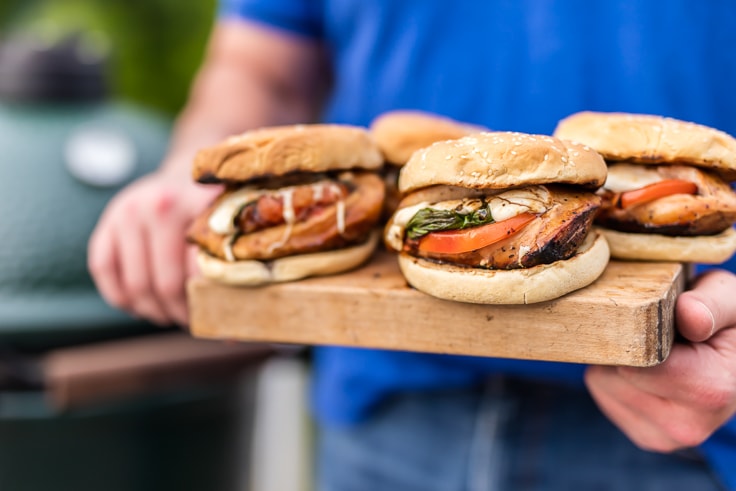 chicken caprese sandwiches on a cutting board