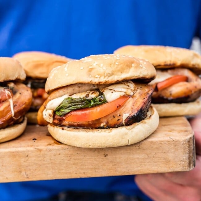 stuffed caprese chicken sandwiches on the wooden platter