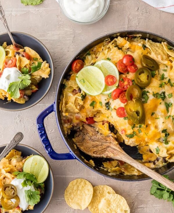 SUPER EASY CHICKEN NACHO CASSEROLE is our favorite Mexican weeknight meal! Throw it together, bake, and enjoy this cheesy, spicy, delicious, EASY Tex Mex meal in just minutes! Layered with chips, cheese, chicken, rotel, and more!