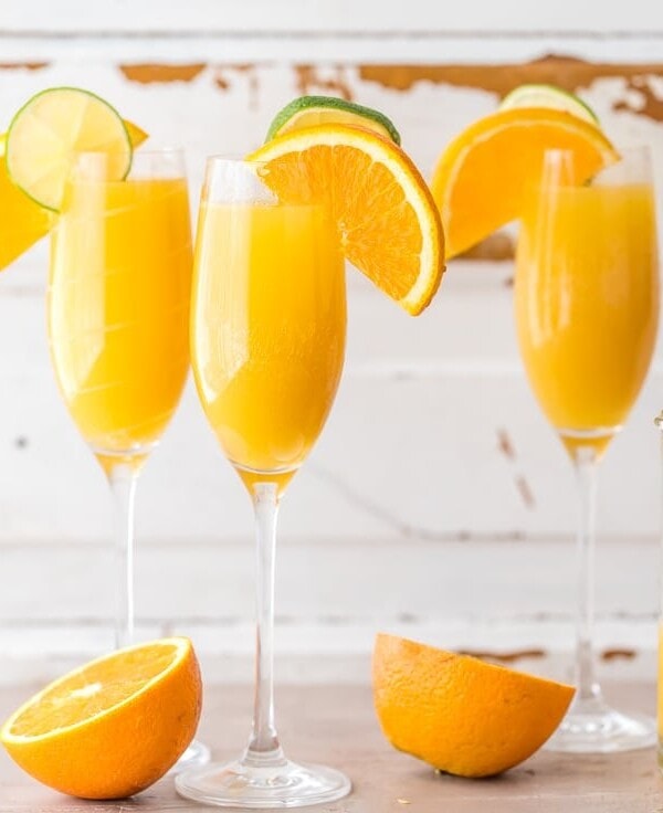 Moscow Mule Mimosas make for the BEST BRUNCH EVER! So easy, unique, delicious, and fun! Spiked ginger beer, orange juice, and champagne! YUM!