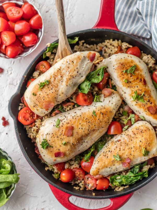 This BLT Chicken and Rice Skillet is the perfect one pan meal to feed the whole family! It's loaded with garlic, chicken, bacon, tomatoes, spinach, and a brown rice & quinoa mix! This chicken and rice recipe is totally delicious and SO EASY!