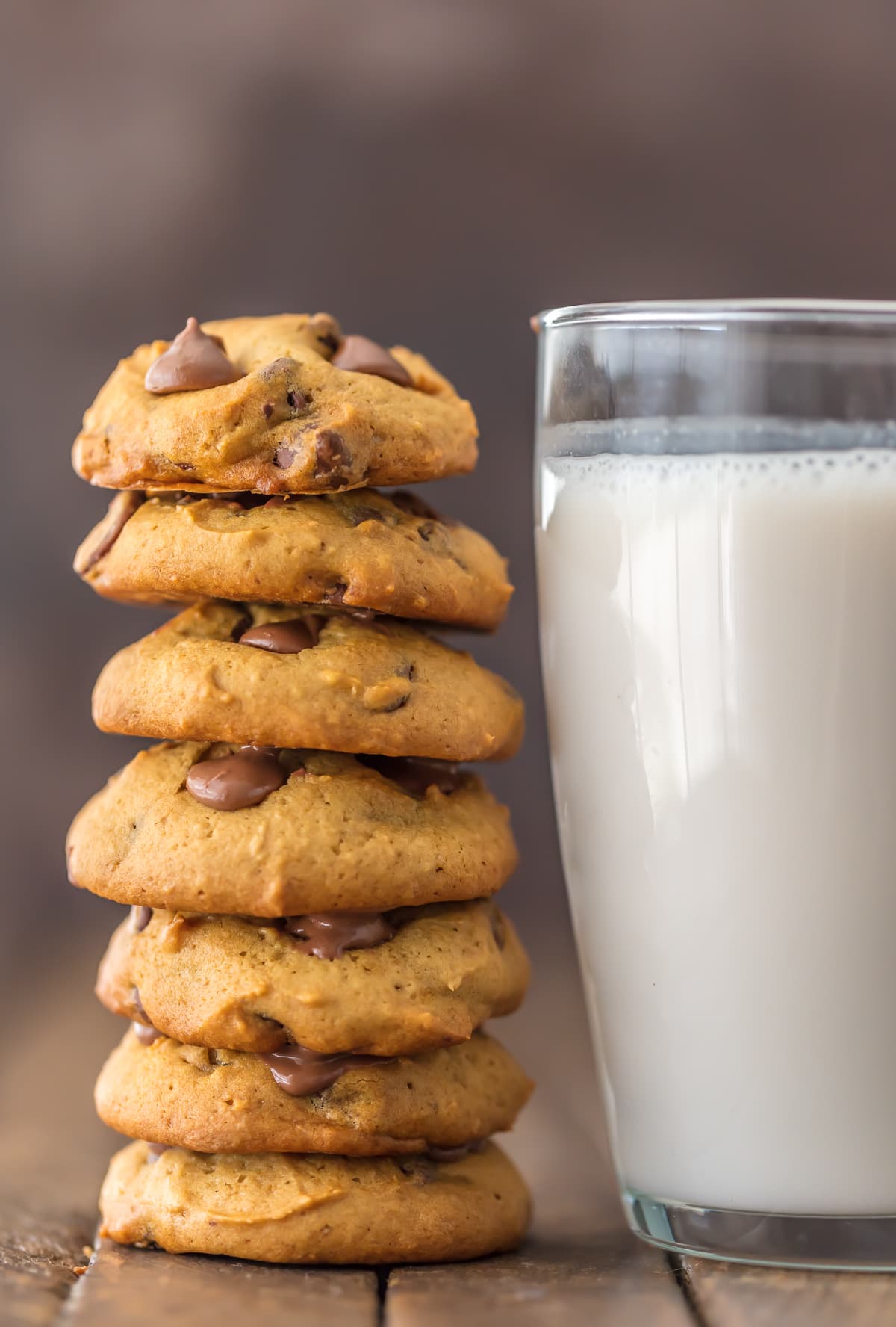 A stack of applesauce chocolate chip cookies next to a glass of milk