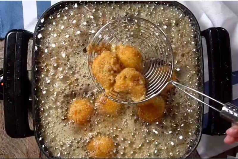 deep frying the coated loaded mashed potato balls