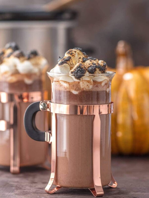 SPIKED PUMPKIN SPICE HOT CHOCOLATE is the ultimate Thanksgiving cocktail! This tasty spiked hot chocolate is made in a slow cooker and it's perfect for serving a crowd. This creamy twist on a classic is a must make for the holidays. Nothing is easier than slow cooker hot chocolate!