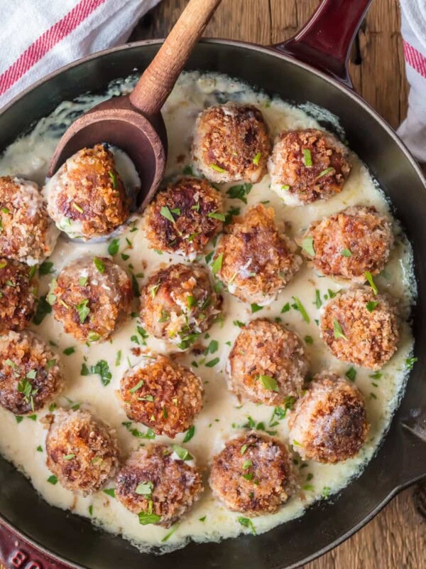 CHICKEN CORDON BLEU MEATBALLS are the most amazing holiday appetizer ever! Chicken meatballs stuffed with swiss and ham, and cooked in a white wine dijon sauce. I could eat these Cordon Bleu Chicken Meatballs for every meal!