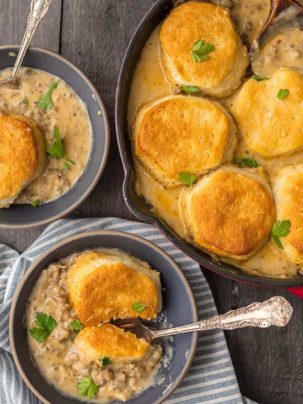 SAUSAGE BISCUIT GRAVY COBBLER is a delicious and easy one pan meal. This skillet breakfast recipe takes classic biscuits and gravy and makes it even better. This sausage and biscuits recipe has quickly become our very favorite Christmas morning breakfast and for good reason. Holiday comfort food at its finest!