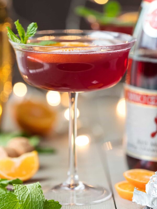 Flirtinis are a fun drink perfect for festive occasions. This Sparkling Holiday Flirtini is so fun, so pretty, and so delicious! It's made from cranberry and pineapple juice mixed with orange vodka, and topped off with red Moscato champagne. It's the perfect holiday cocktail recipe for Christmas or New Year's Eve!