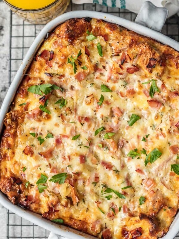 This HAM AND CHEESE BREAKFAST CASSEROLE is our favorite make ahead breakfast for any special occasion. Loaded with ham, cheese, , bread, eggs, herbs, and more! Sure to please everyone and just so easy to make!