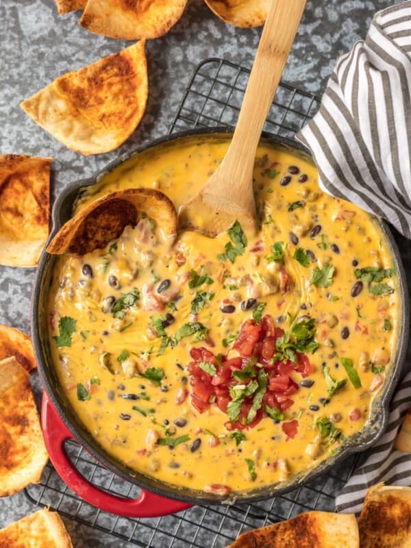 Cowboy Dip Queso (Loaded Velveeta Queso Dip) is the ultimate Super Bowl appetizer. This EASY Rotel Dip recipe is loaded with Velveeta, beer, pepper jack, black beans, Rotel, and sausage!