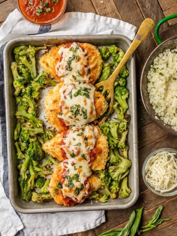 baked chicken parmesan on baking dish with broccoli