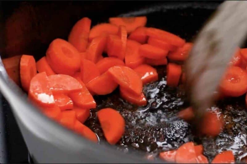 cooking diced carrots in bacon fat in dutch oven