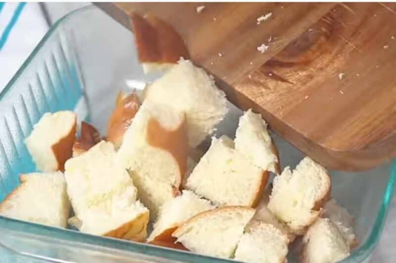 cut brioche bread into cubes and add into baking sheet