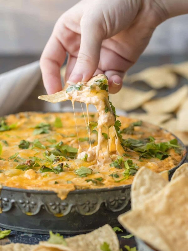 This GREEN CHILE CHICKEN ENCHILADA DIP is the ultimate party food, loaded with chicken, green chiles, cream cheese, sour cream, and so much more. It will be gone in minutes from any get together.