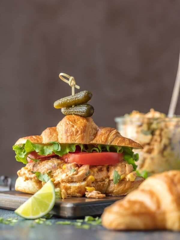 Make lunch spectacular with MEXICAN CHICKEN SALAD SANDWICHES! This easy twist on a classic is sure to please everyone at the table. Chicken salad loaded with taco seasoning, corn, peppers, and enchilada sauce. SO GOOD!