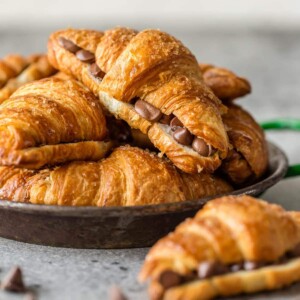 sheet pan chocolate croissants stacked on a plate