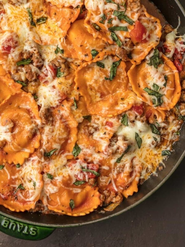 CHEESE RAVIOLI is a classic pasta dish, but I took it up a notch with this One Pan Cheese Ravioli Skillet. It's loaded with cheese-stuffed ravioli, Italian sausage, more cheese, tomatoes, and basil. It’s a simple and fun one pan dinner that everyone will ask for again and again. This cheese ravioli recipe is sure to please the entire family!