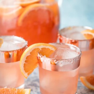 salty dog sangria coktails in front of a pitcher of sangria