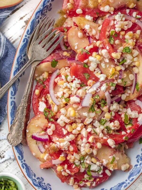 This PEACH TOMATO CORN SALAD WITH SPICY HONEY VINAIGRETTE is so fresh, delicious, and easy. Make it as a side or a meal, its delicious throughout the day. SO MUCH FLAVOR.