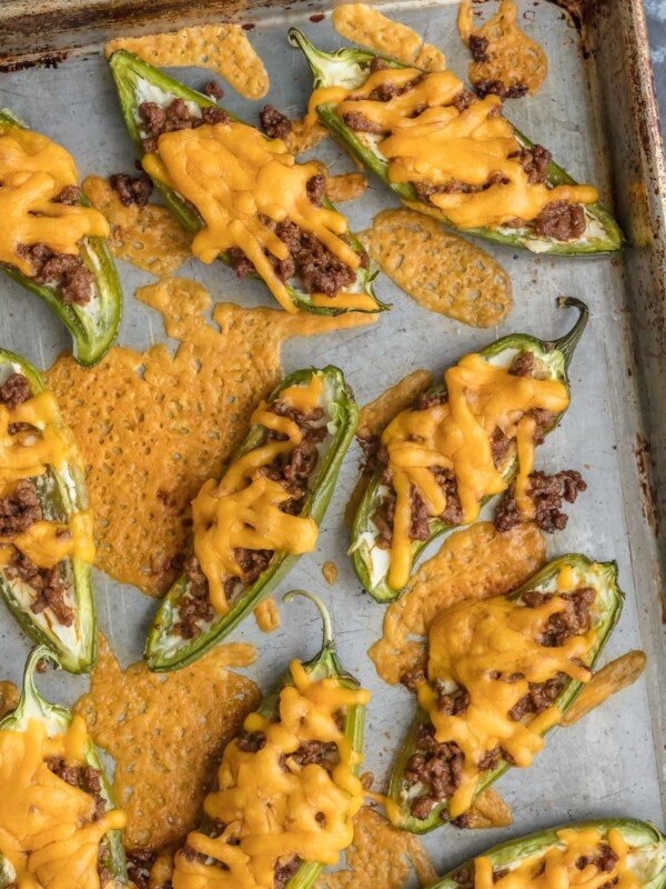 This CHEESEBURGER STUFFED JALAPENO POPPERS recipe is a fun and delicious game day appetizer! We love these spicy bites for tailgating, parties, or a tasty night spent at home.