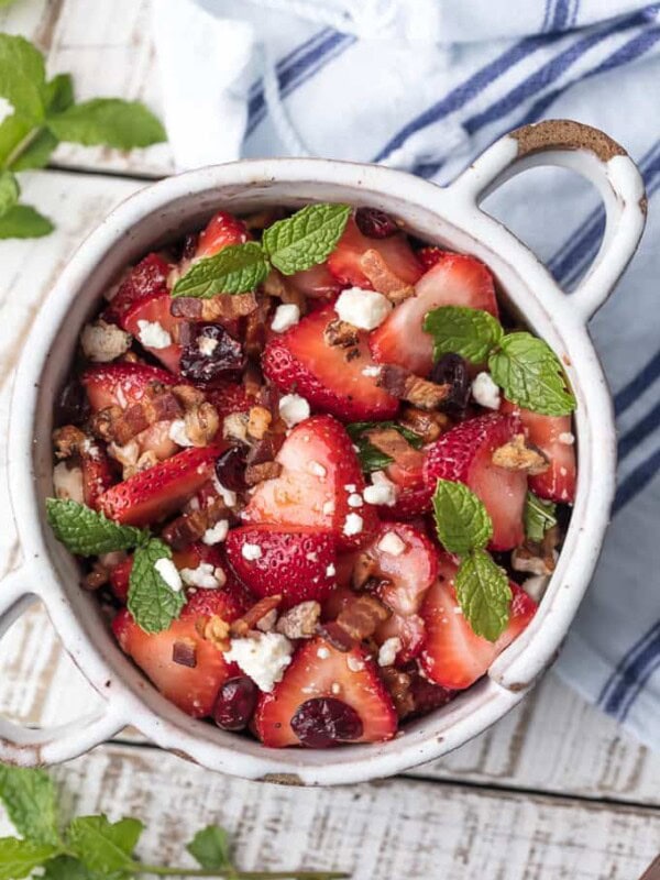 This STRAWBERRY BACON SALAD with HONEY LIME BALSAMIC VINAIGRETTE salad dressing is the perfect salad for summer. Fresh, sweet, savory, and rich, with feta, pecans, and mint on top.