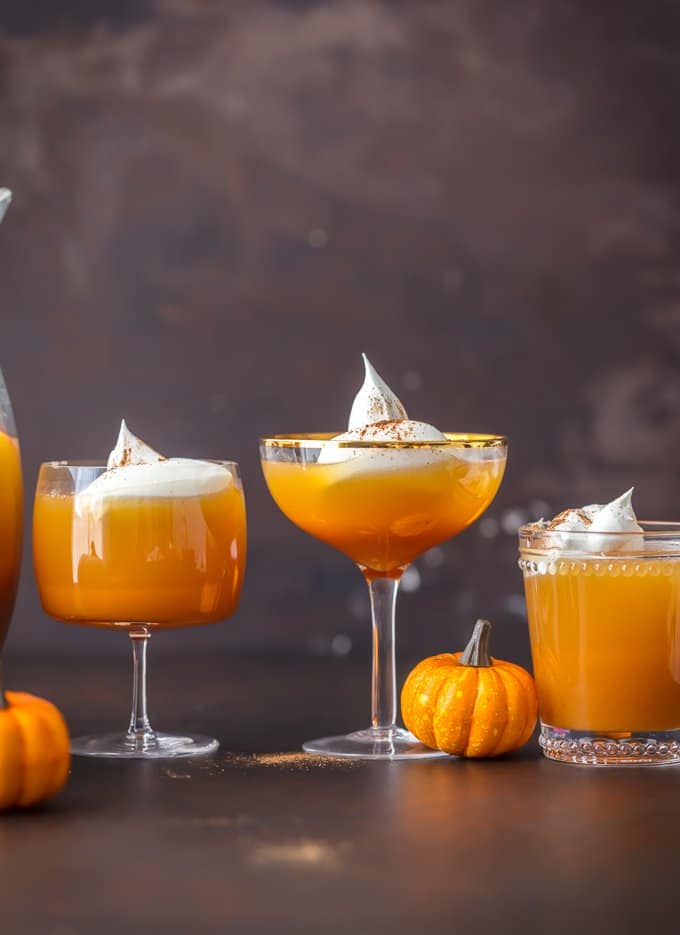 Glasses of pumpkin cocktails topped with whipped cream