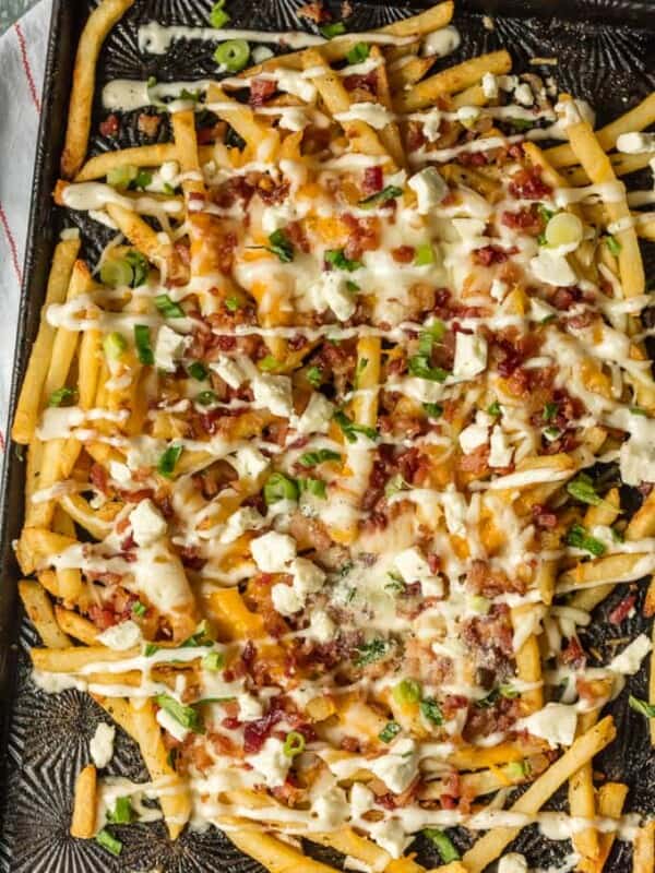 Nothing makes game day delicious more than 3 CHEESE BACON RANCH FRIES. This easy and fun appetizer takes crispy fries and tops them with ranch seasoning, bacon, cheddar, mozzarella, and feta.