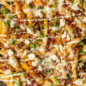 Nothing makes game day delicious more than 3 CHEESE BACON RANCH FRIES. This easy and fun appetizer takes crispy fries and tops them with ranch seasoning, bacon, cheddar, mozzarella, and feta.