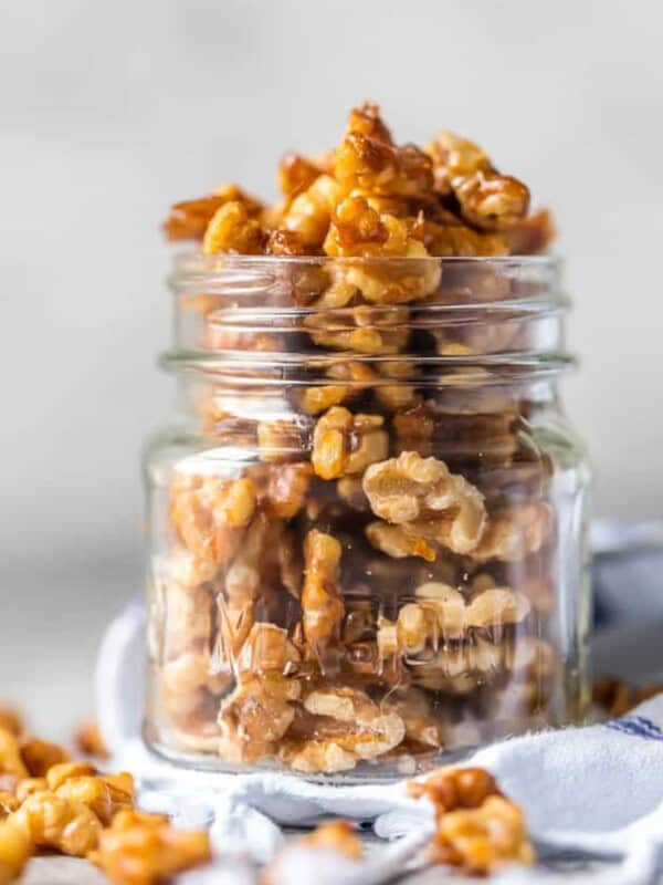 Walnuts in a glass jar with a spoon - candied walnuts.