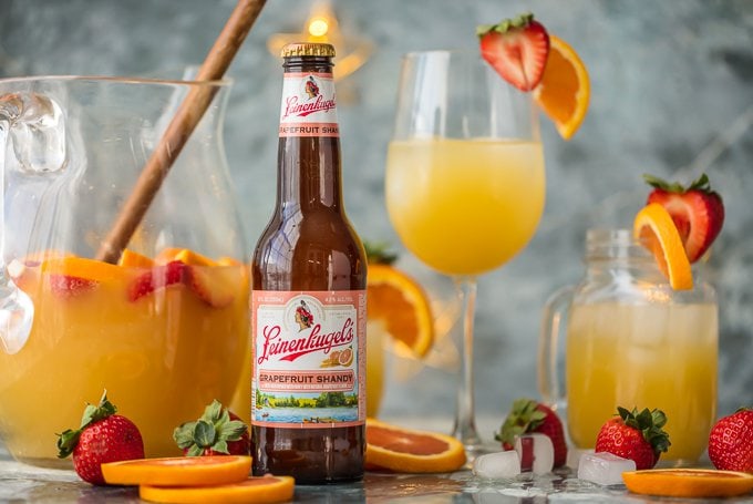 grapefruit beer sangria in glasses with a bottle of grapefruit beer