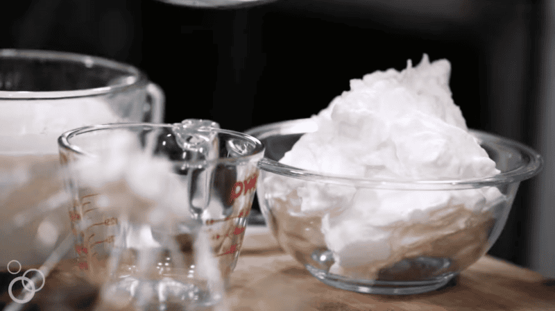 beaten fluffy egg whites in a glass bowl.