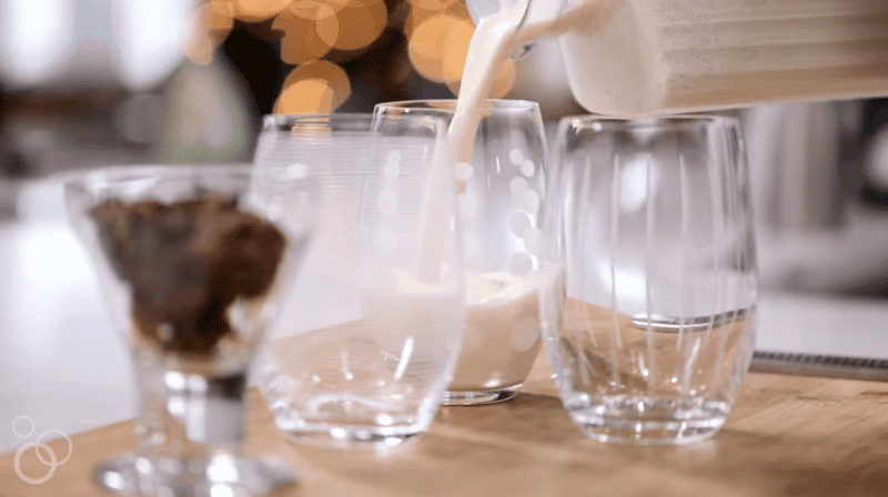 pouring eggnog into glasses.