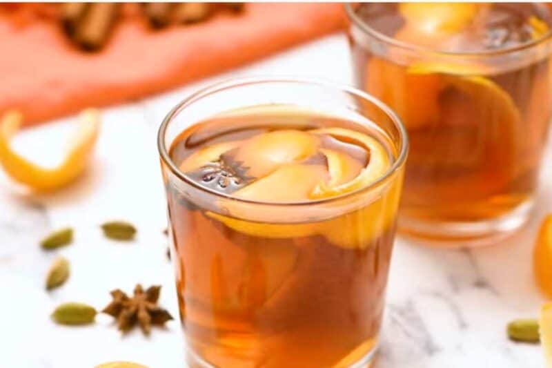 garnish with orange peel and star anise and serve in glasses