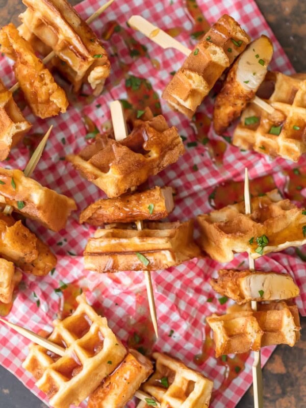 This Mini Chicken and Waffles Recipe is such a cute and delicious appetizer. These MINI CHICKEN AND WAFFLES ON A STICK are so fun and perfect for celebrating! Whether its the holidays or game day, these will wow any crowd. I love that these Mini Chicken and Waffles are the perfect size. So delicious with syrup!