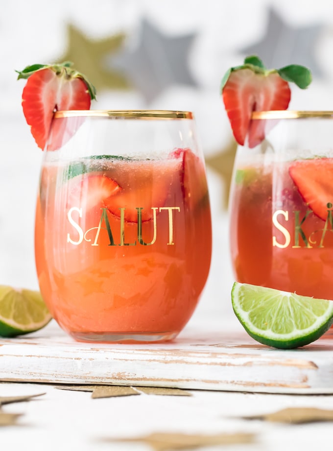 This fun and festive SPARKLING STRAWBERRY MARGARITA PUNCH is such a delicious and easy party drink recipe. Strawberry Limeade meets Margaritas in the most amazing beverage. Cheers to New Years Eve, Cinco De Mayo, and more!